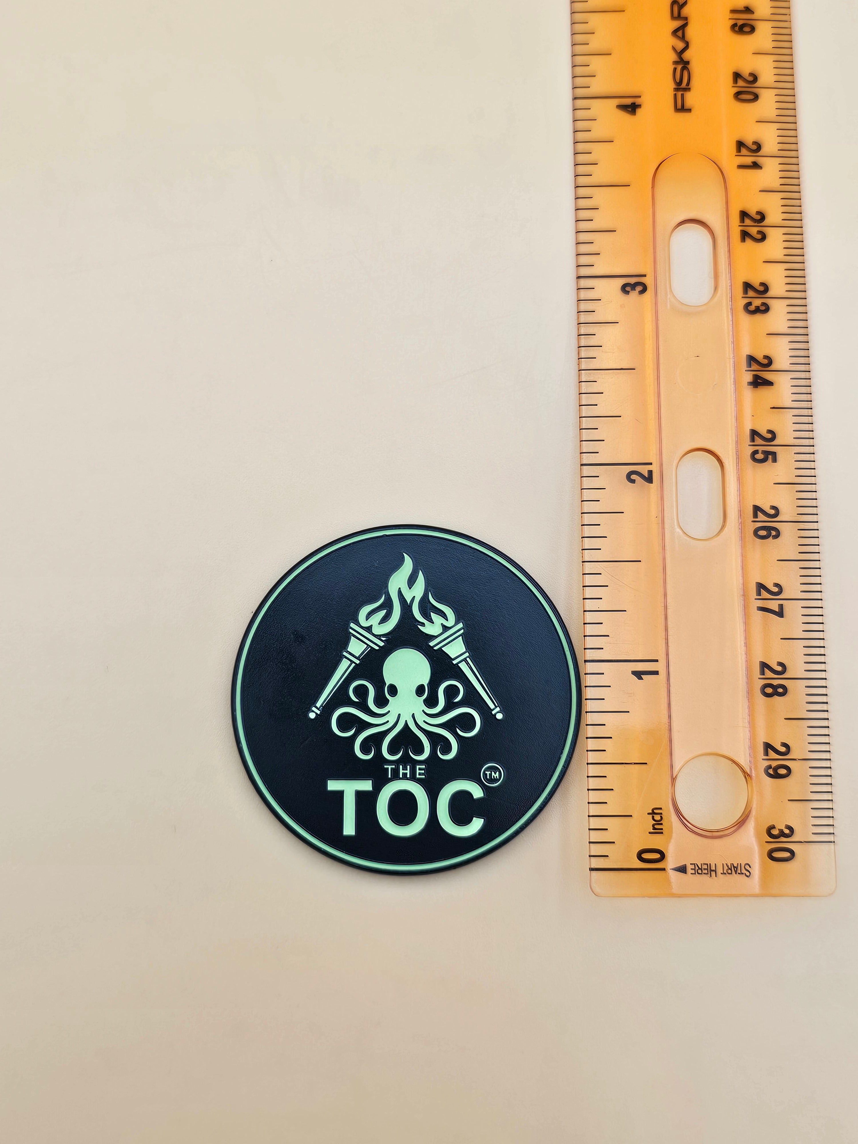 The TOC Founding Challenge Coin – Numbered Glow-in-the-Dark Edition