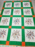 Vintage handmade patchwork quilt featuring a 3x4 grid of embroidered butterfly and floral motif blocks,