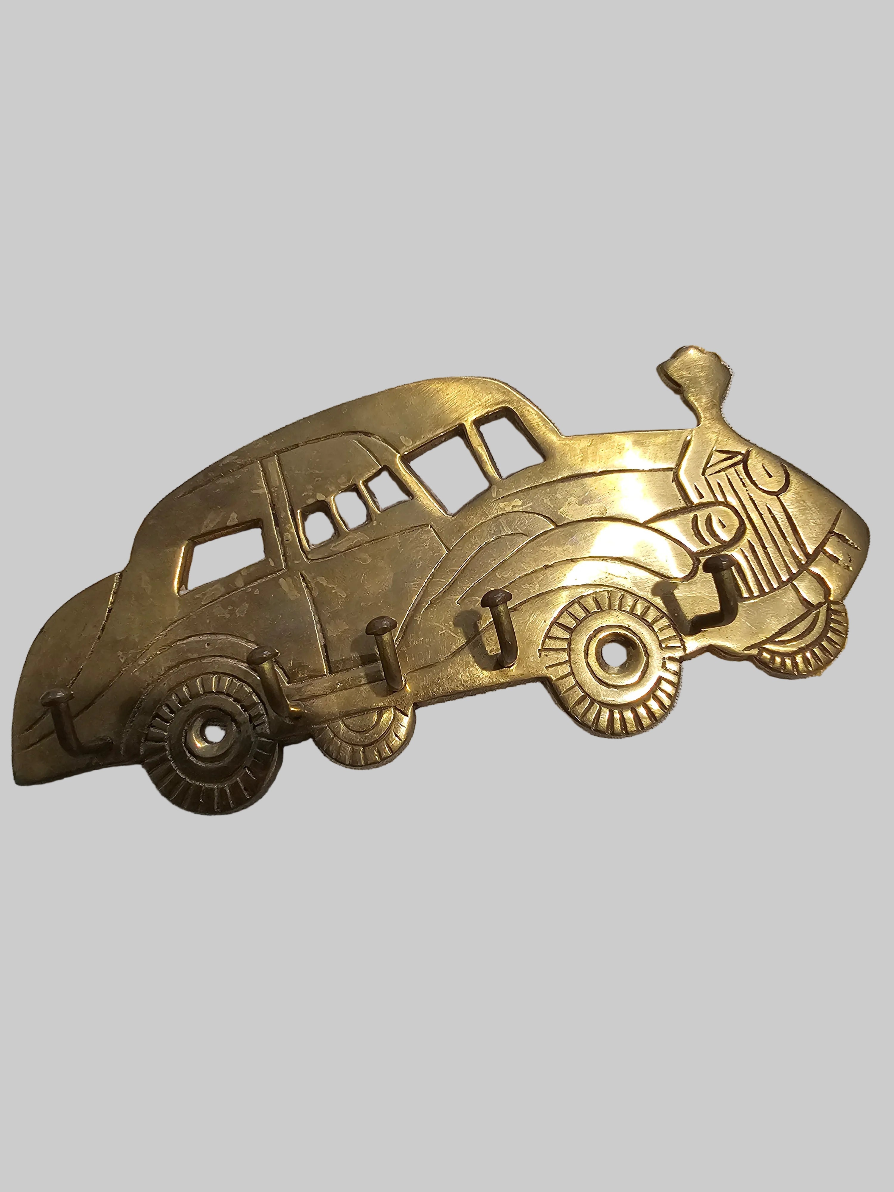 Vintage solid brass wall-mounted key holder shaped like a classic 1920s or1930 cars